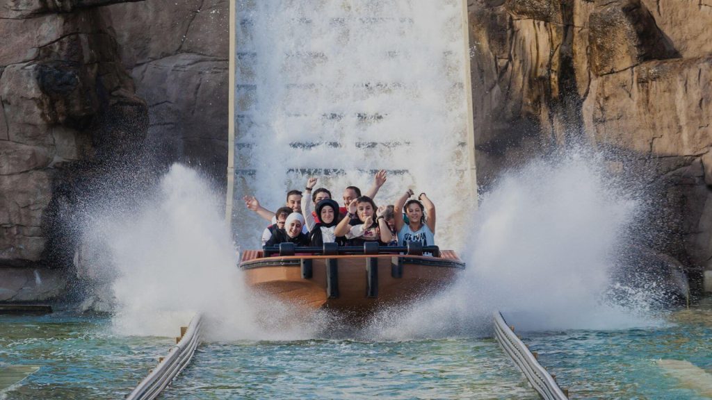 Families enjoying a water ride at a UK theme park — fun kid-friendly attraction for summer trips.