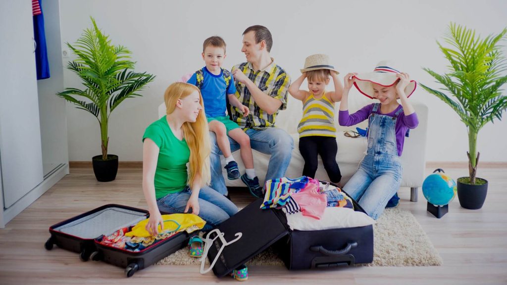 Family packing suitcases and getting ready for a UK staycation with kids.