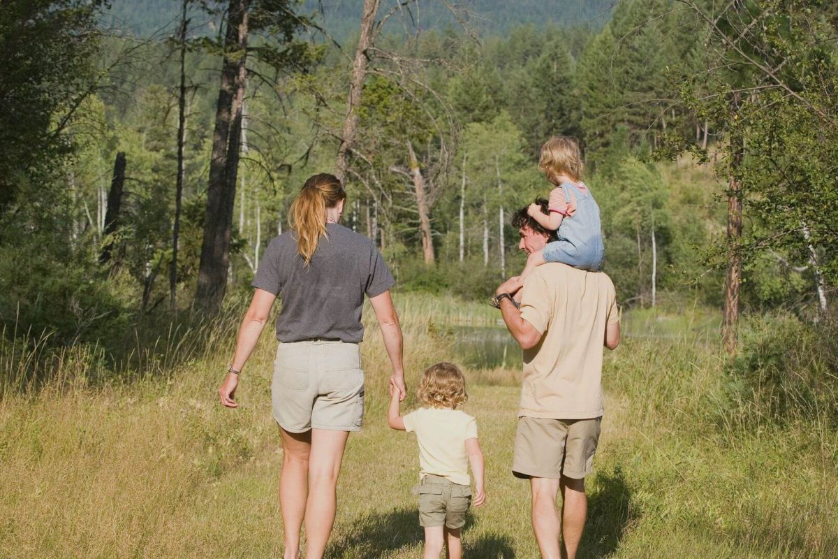 Family walking through the UK countryside on a cozy, budget-friendly trip.